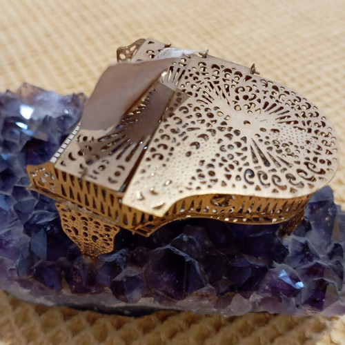 Vintage decorative piano on natural amethyst rock, gold-plated