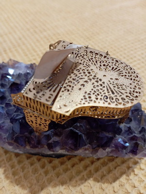 Vintage decorative piano on natural amethyst rock, gold-plated