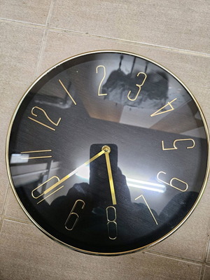 Wall clock like new with black dial and gold hands
