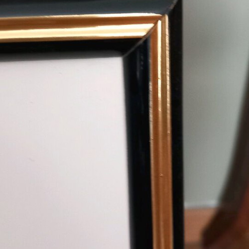 Photo frame with gold and black passepartout finish