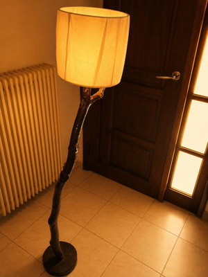 Rustic wooden floor lamp with natural tree trunk and dusty rose cable