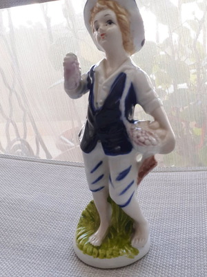 Porcelain figurine of a young man like new with vivid colors