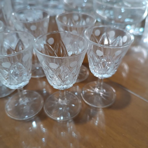 Set of 17 crystal glasses and bowls with carved details