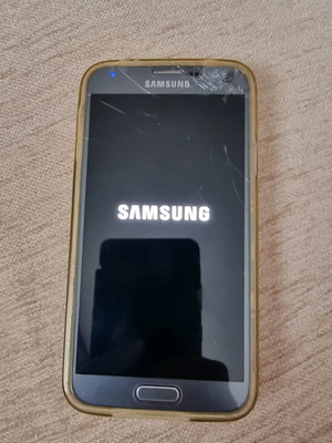 Samsung Galaxy S5 Neo smartphone used with charger and case