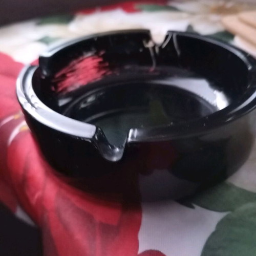 Glass ashtray vintage black classic with four cigarette slots used