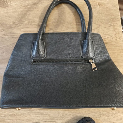 Black handbag used with embossed texture and adjustable strap