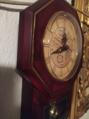 Small wall pendulum clock used, analog