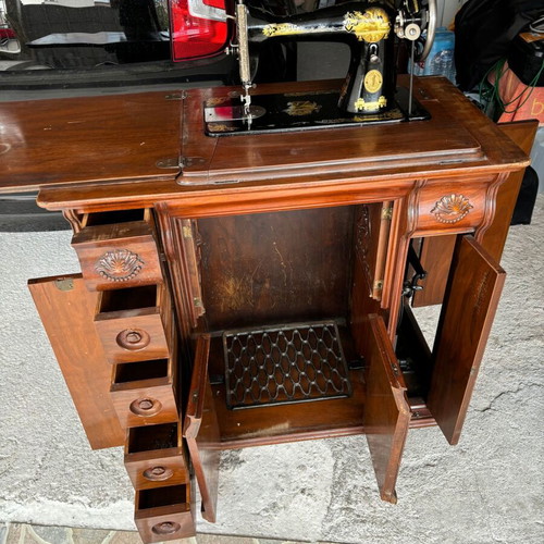 Singer sewing machine in carved furniture used, antique