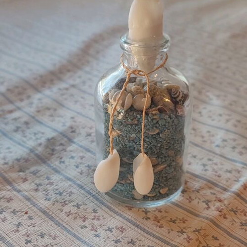 Glass bottle like new with shells and colorful sand