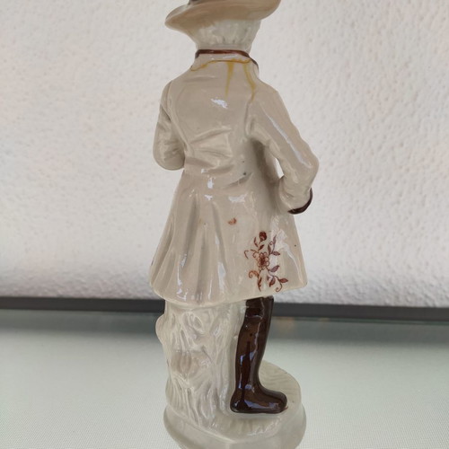 Porcelain decorative figure of man used with musical instrument