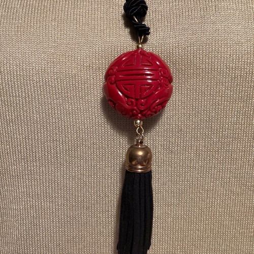 Long pendant like new with red carved bead and black fabric cord