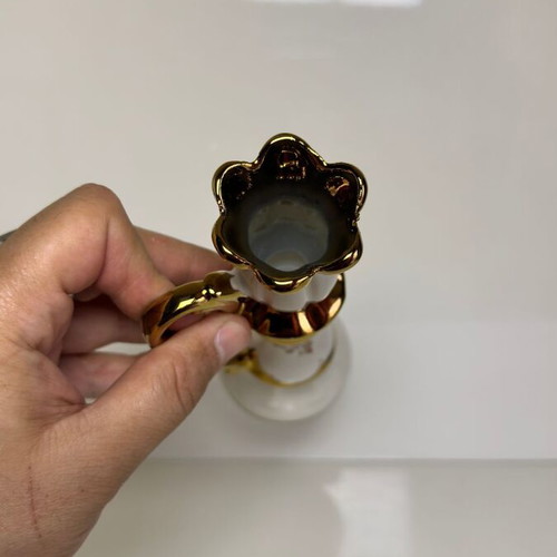 Ceramic candlestick with gold details and floral cross design