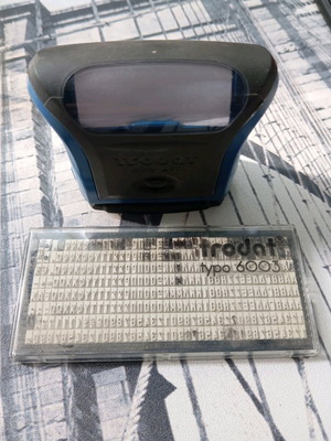 Small stamp used with rows of letters and numbers without handle
