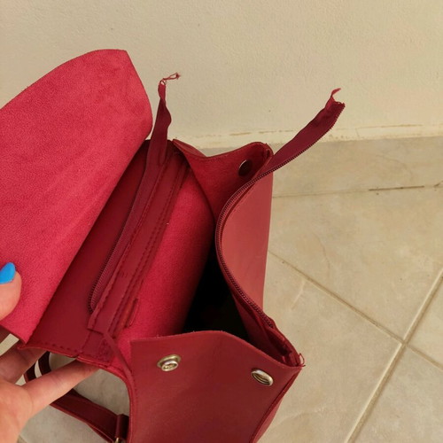 Red backpack used with broken zipper and mark