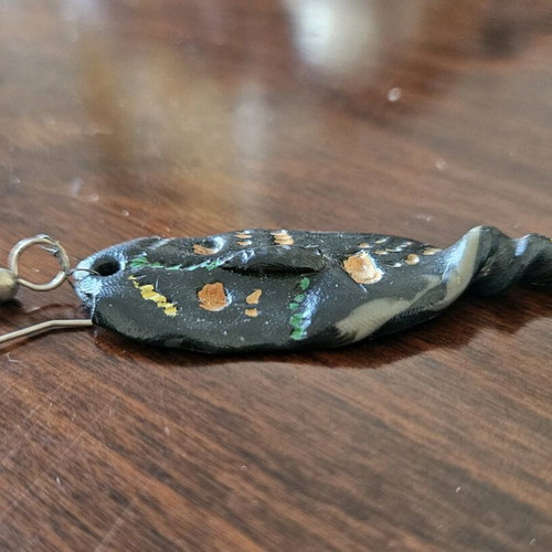 Black earring used, totem-inspired with multicolor pattern