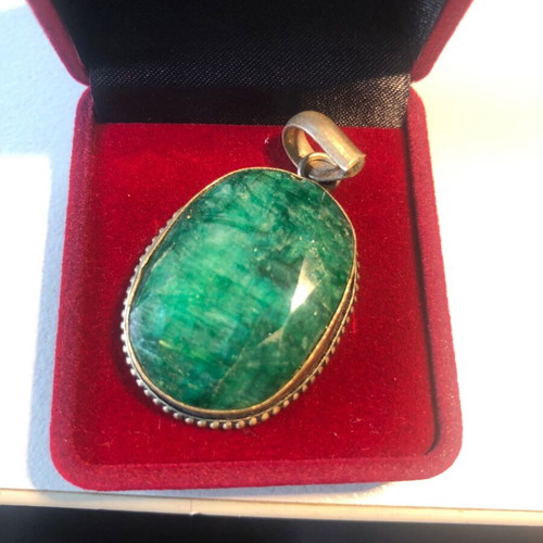 Necklace of smelted emerald like new with black ribbon