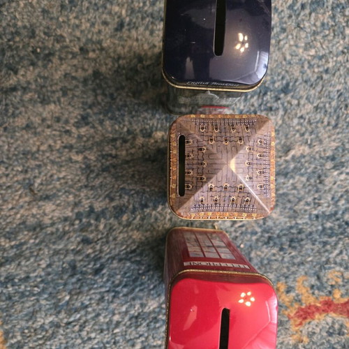 Set of three tin piggy banks like new from England