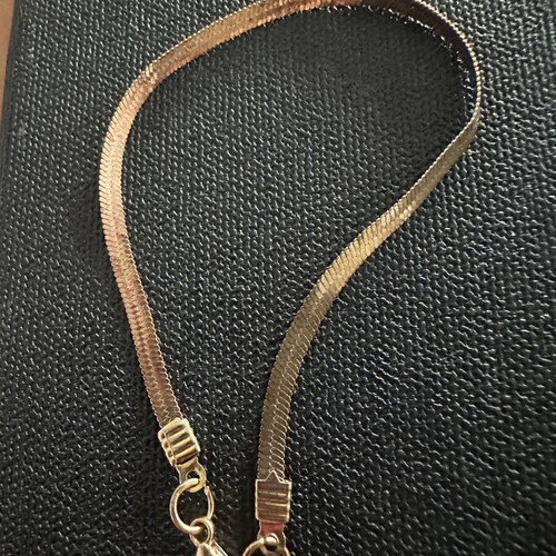 Gold plated bracelet snake chain herringbone style, worn with oxidation spots