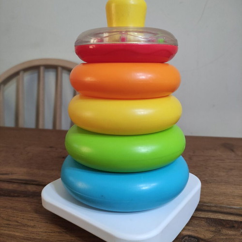 Fisher-Price stacking pyramid like new, 5 colorful rings with rattle base