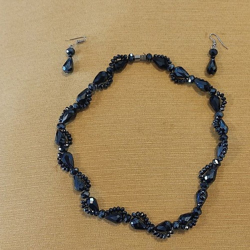 Jewelry set used with dark-colored stone necklace and earrings