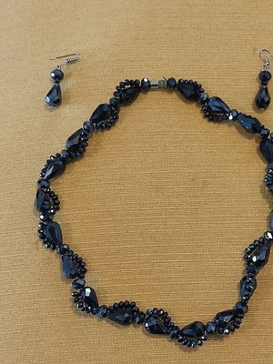Jewelry set used with dark-colored stone necklace and earrings