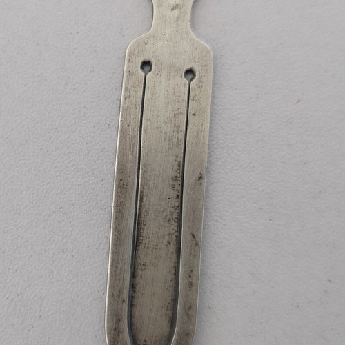 Silver bookmark with cross-shaped handle, used