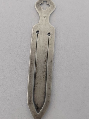 Silver bookmark with cross-shaped handle, used