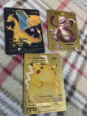 Pokemon cards Charizard V, Mewtwo EX, Pikachu VMAX