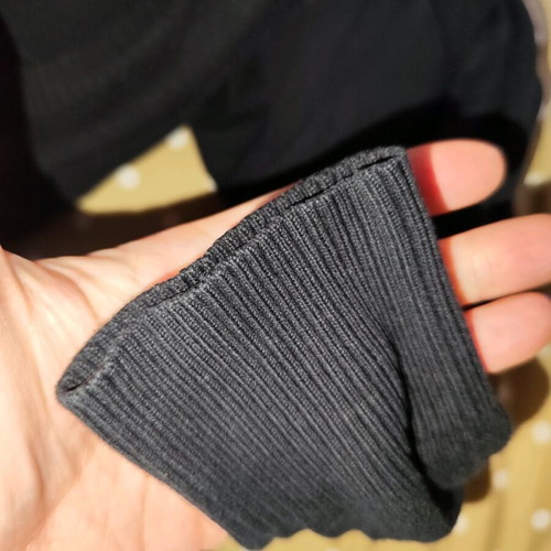 Black sweater used, medium size with loose fit and small hole