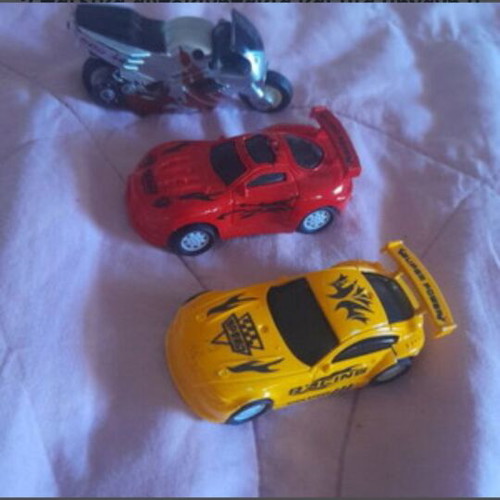 2 children's toy cars and 1 toy motorcycle