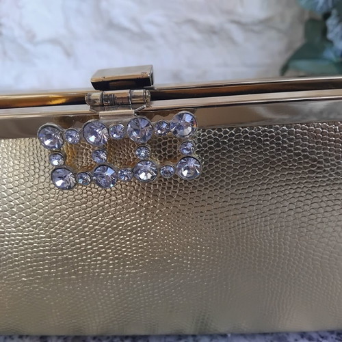 Gold evening clutch bag with rhinestones and metal frame