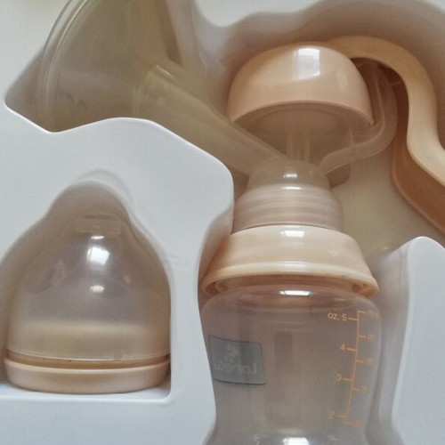 Manual breast pump new with nipple and bottle