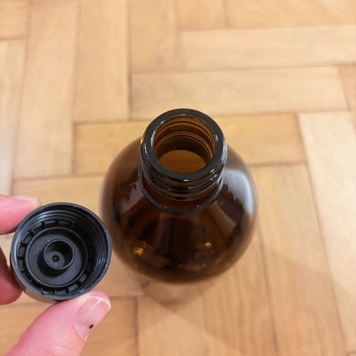 Brown glass pharmacy-style bottle with cap