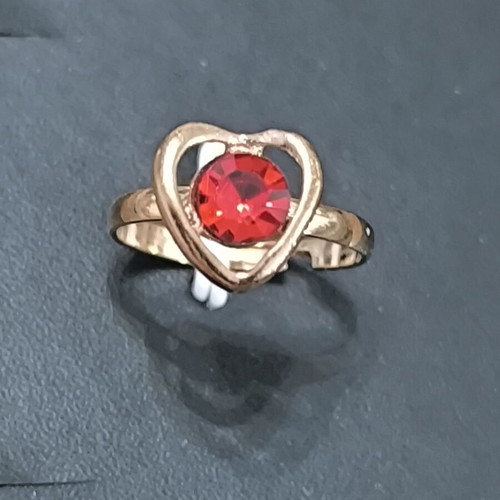 Gold-colored ring with heart and red stone, new