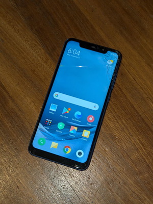 Xiaomi Redmi Note 6 Pro smartphone with cracked display and camera glass
