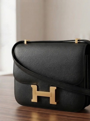 Hermes black crossbody bag with gold H clasp