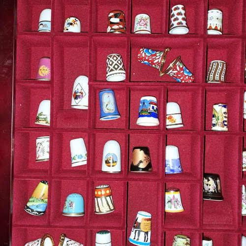 Porcelain thimble collection with wooden display case and book