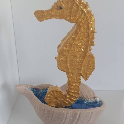 Handmade decorative gold seahorse from clay and resin with brown shell base