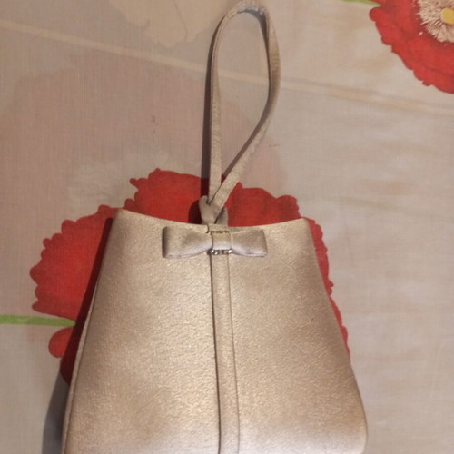 Silver satin evening bag with bow and wrist strap