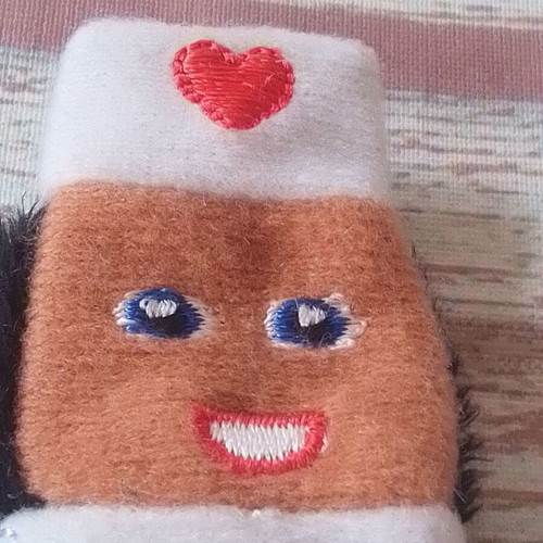Plush finger puppet nurse used for puppet theater
