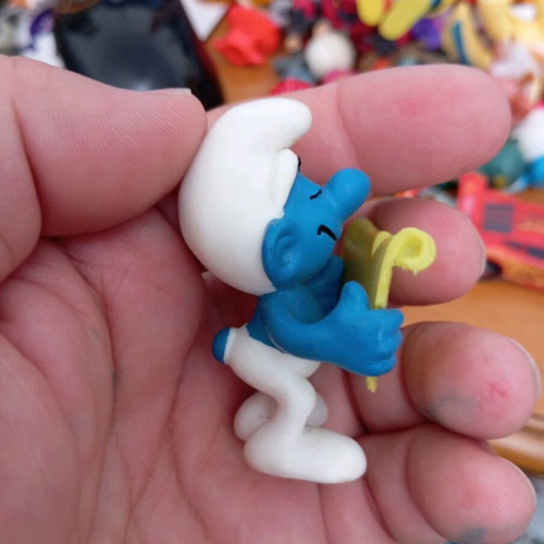 Smurf figure used reading a book