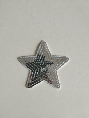 Sewn patch in silver star shape like new