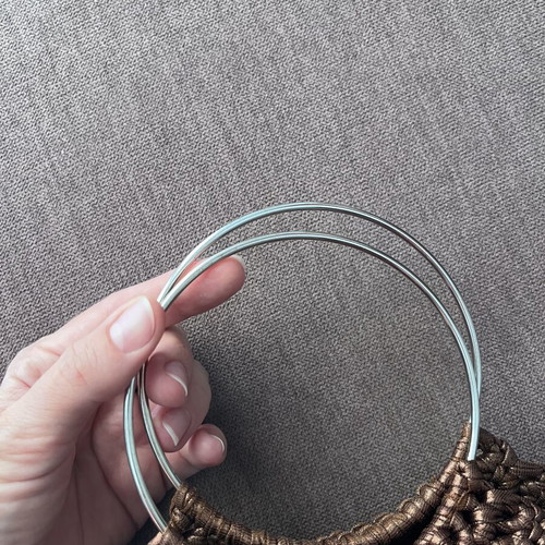 Brown metallic knitted handbag with silver ring handles