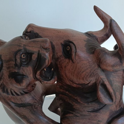 Hunting scene with buffalo and predators wood carving
