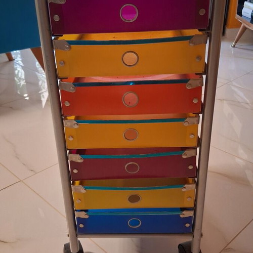 Modern wheeled drawer unit used with seven colorful plastic drawers