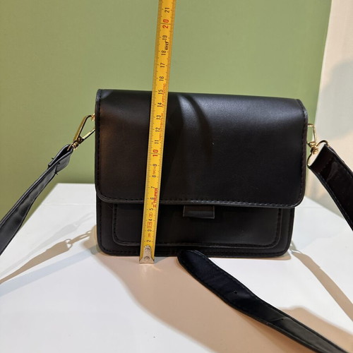 Black women's crossbody shoulder bag with gold details