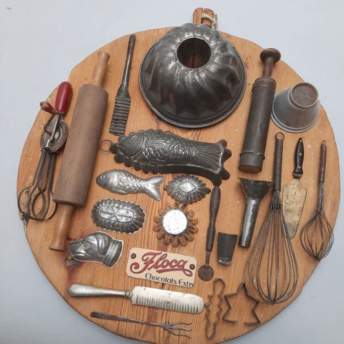 Collection of vintage pastry tools on wooden board