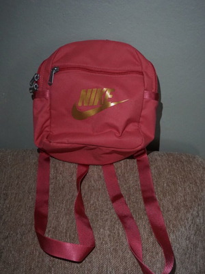 Nike mini backpack like new with gold logo, red