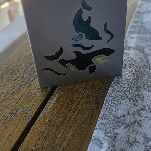 Metal tealight holder with stained glass dolphins