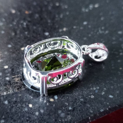 Pendant with green lab topaz in silver-plated base like new